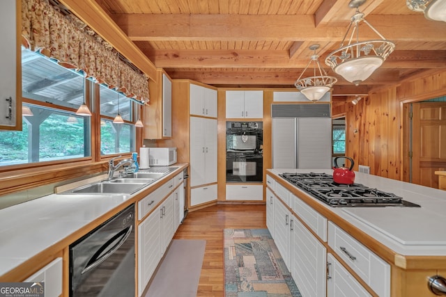 kitchen featuring wooden ceiling, beamed ceiling, white cabinets, and black appliances