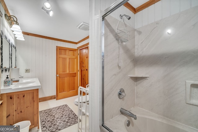 bathroom featuring vanity, tiled shower / bath, and crown molding