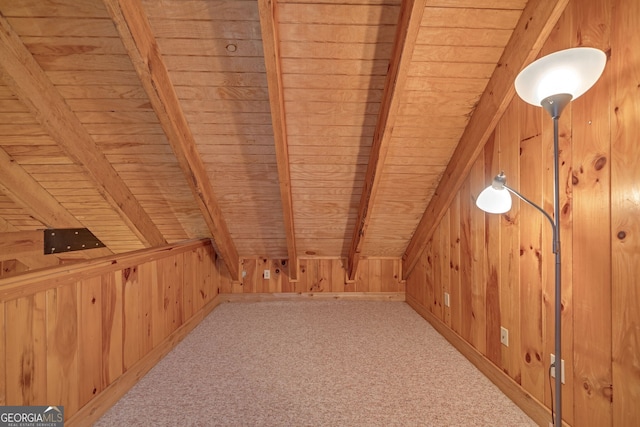 bonus room with carpet flooring, lofted ceiling with beams, wood walls, and wood ceiling