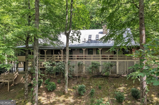 rear view of property featuring a deck