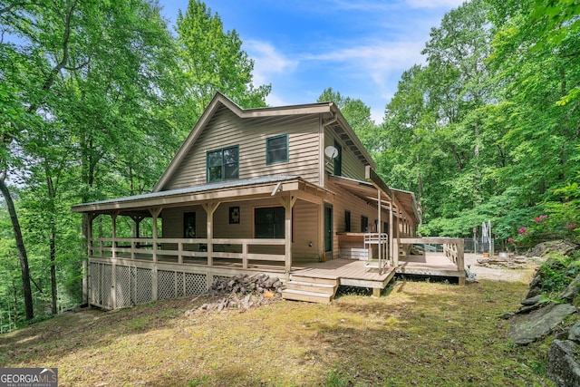 back of house featuring a wooden deck