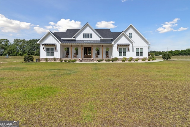 modern farmhouse style home with a porch and a front lawn