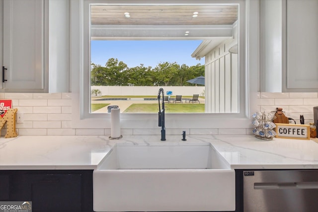 2879 Lakeview Rd, Statesboro, GA 30461 - kitchen featuring stainless steel dishwasher, a sink, decorative backsplash, and light stone countertops