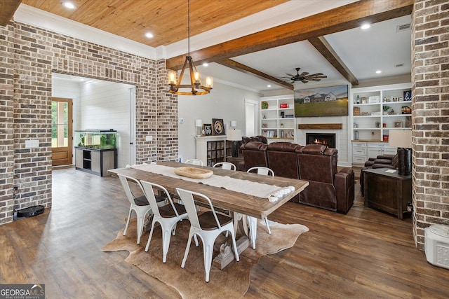 2879 Lakeview Rd, Statesboro, GA 30461 - dining area featuring a warm lit fireplace, a ceiling fan, dark wood finished floors, brick wall, and crown molding