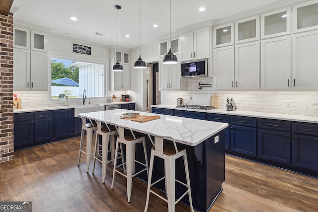 2879 Lakeview Rd, Statesboro, GA 30461 - kitchen with blue cabinets, a sink, a center island, stainless steel appliances, and backsplash
