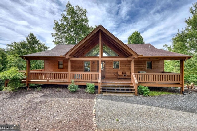 log home with roof with shingles