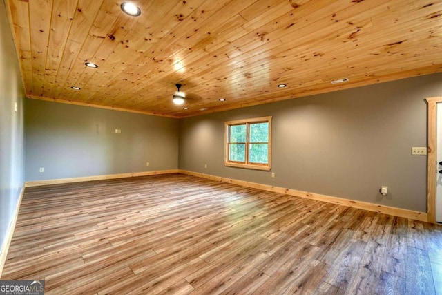 spare room featuring wood ceiling, baseboards, and wood finished floors