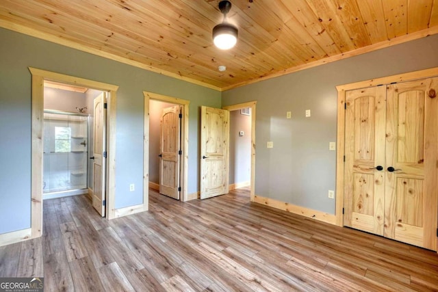 unfurnished bedroom with ornamental molding, wood finished floors, wood ceiling, and baseboards