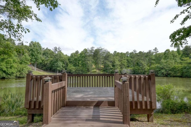 wooden deck featuring a water view