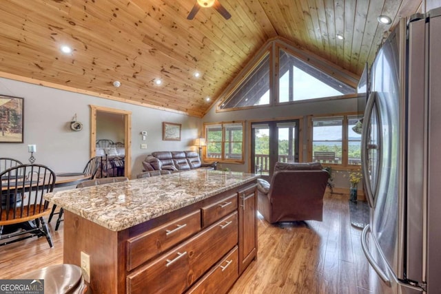 kitchen featuring wooden ceiling, open floor plan, light wood-style floors, and freestanding refrigerator