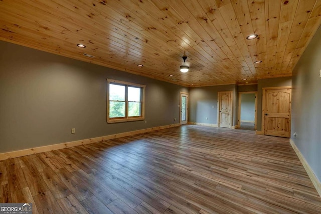 spare room with recessed lighting, wood ceiling, baseboards, and wood finished floors