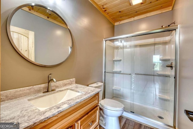 bathroom with toilet, wooden ceiling, a shower stall, and vanity