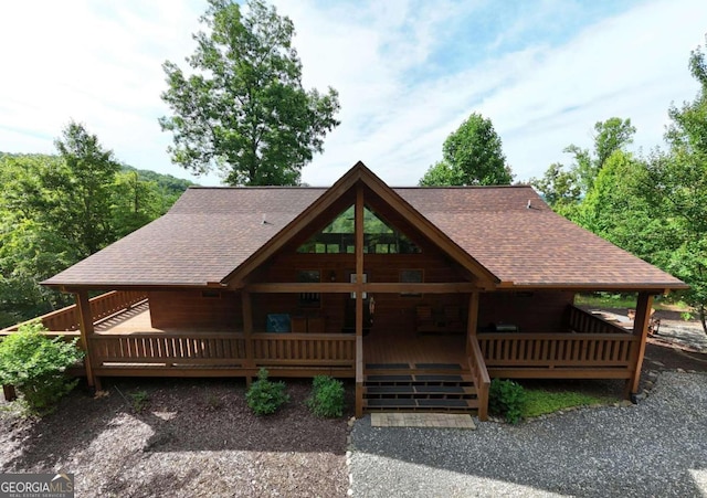 view of front of property with a shingled roof and a porch