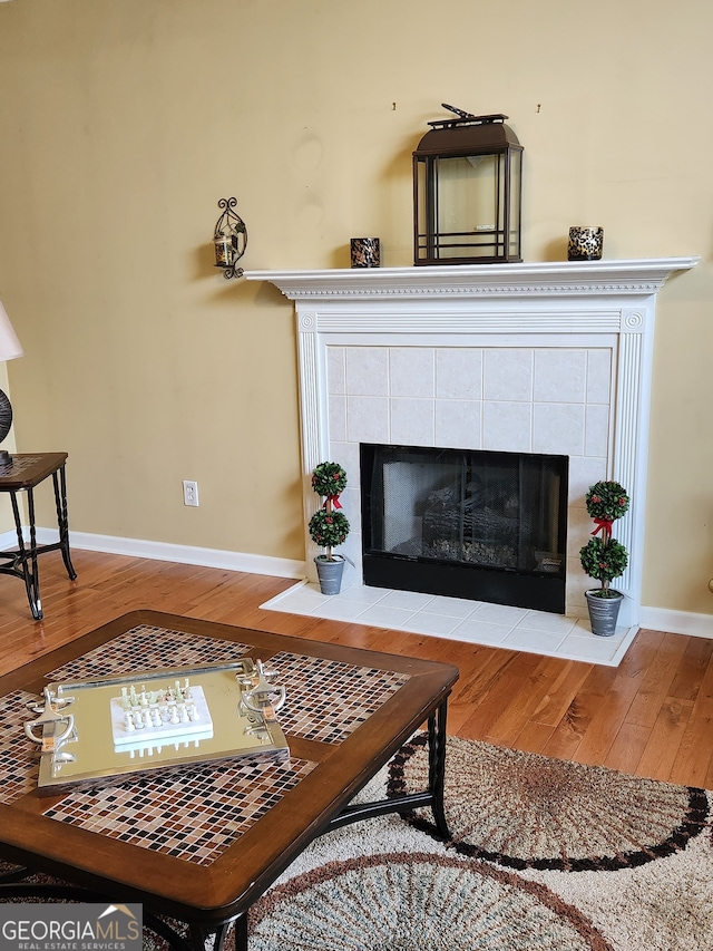 living room with a fireplace and light wood-type flooring