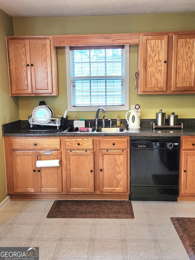 kitchen with dark stone countertops, a textured ceiling, black dishwasher, and sink