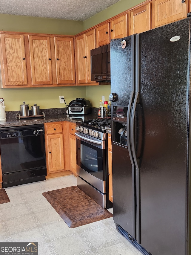 kitchen with black appliances and a textured ceiling