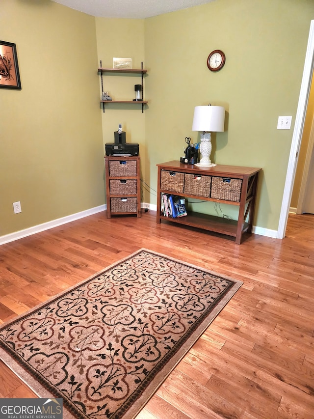 interior space featuring wood-type flooring and a textured ceiling