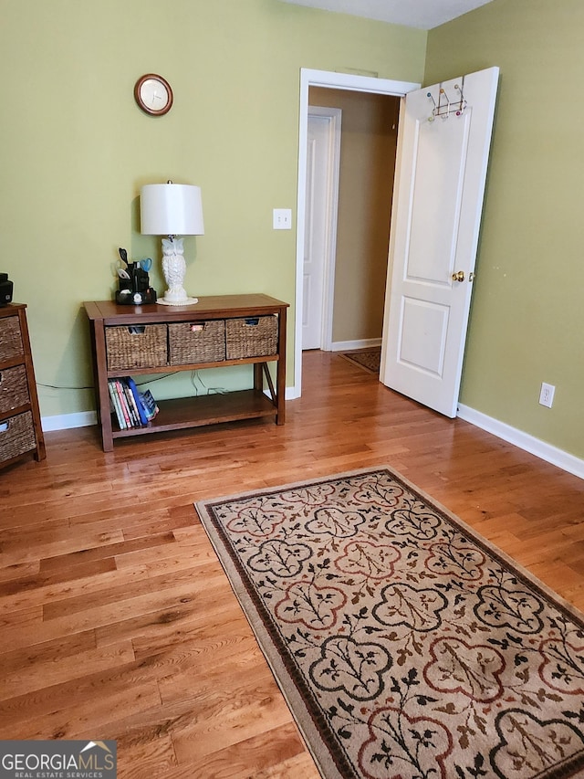 bedroom with light wood-style flooring and baseboards