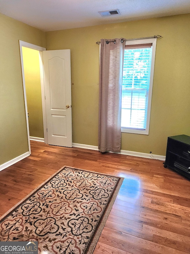 empty room with wood finished floors and baseboards