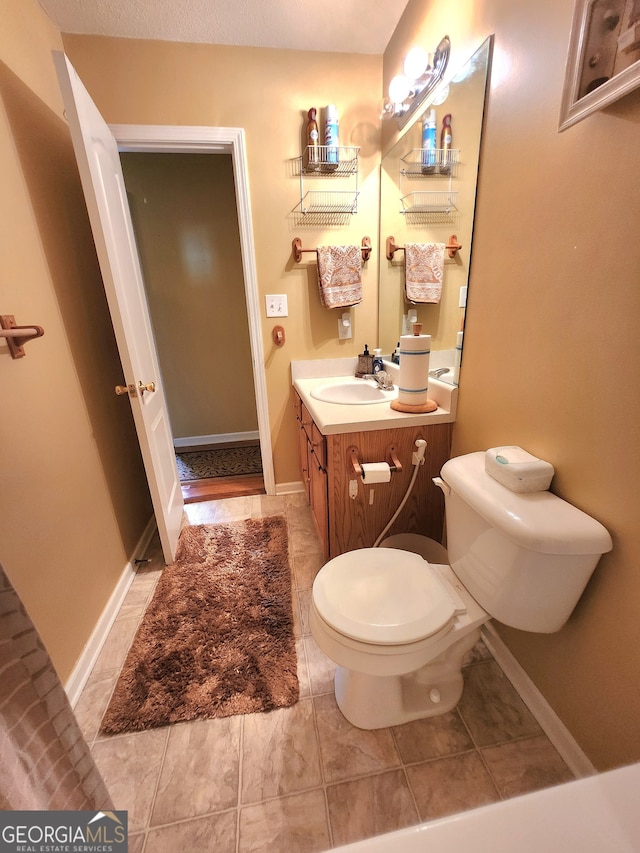 bathroom featuring vanity, toilet, and tile patterned floors