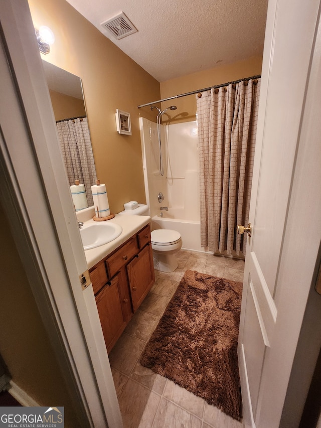 full bathroom with vanity, a textured ceiling, shower / bath combo, and toilet