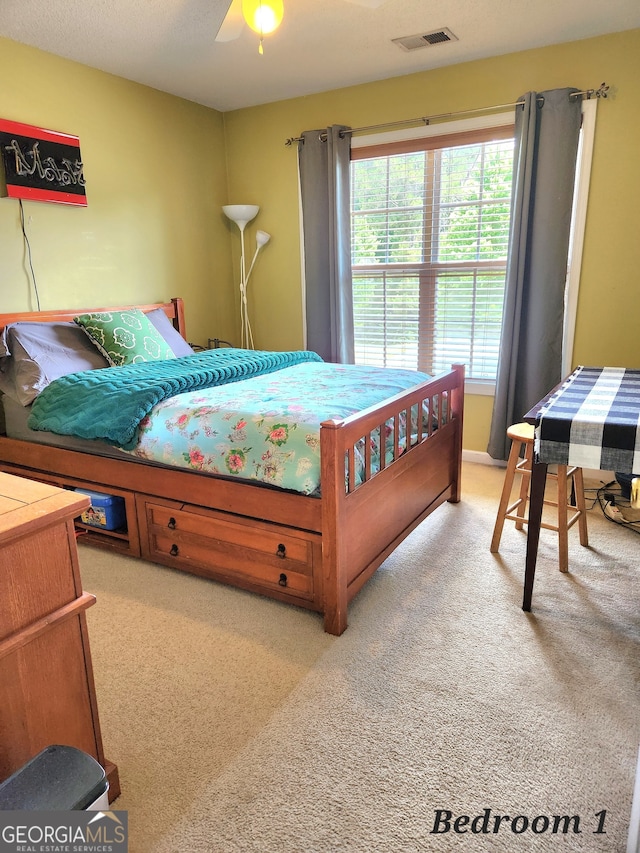 bedroom with light carpet and ceiling fan