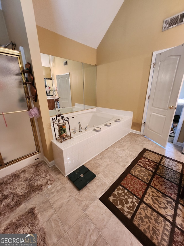 bathroom with tile patterned flooring, vaulted ceiling, and shower with separate bathtub