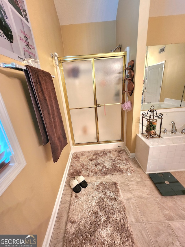 bathroom featuring tile patterned flooring and separate shower and tub