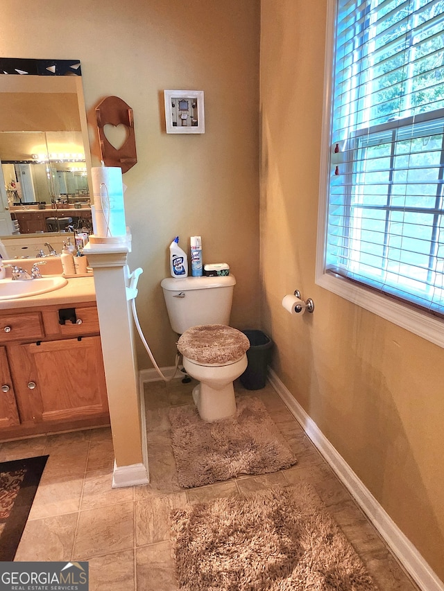 bathroom featuring vanity, toilet, and tile patterned floors