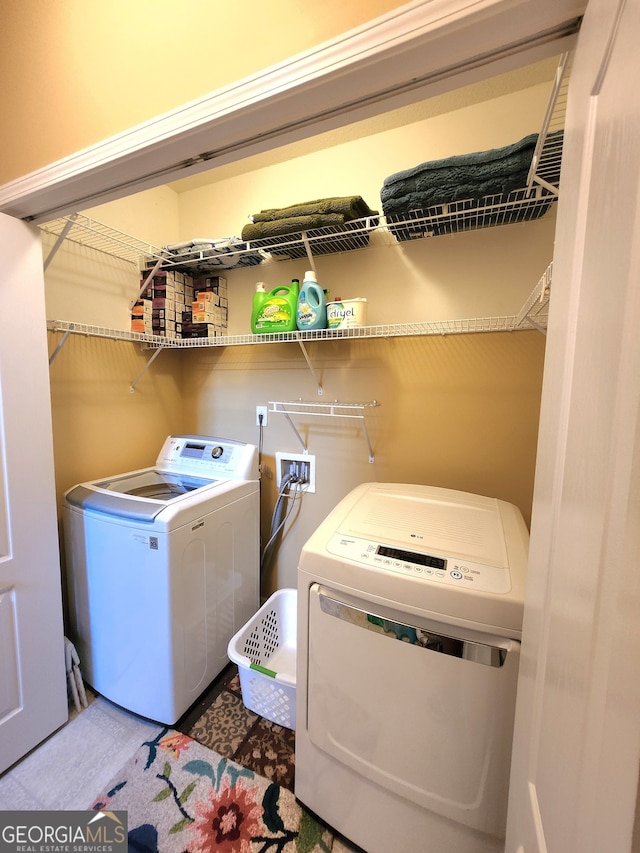 clothes washing area with washer and dryer