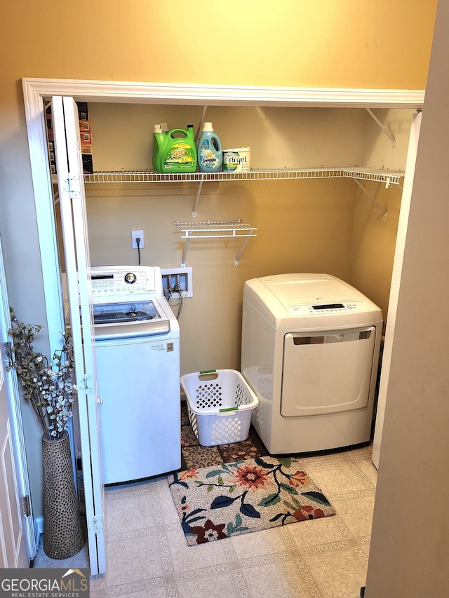 clothes washing area with washing machine and clothes dryer