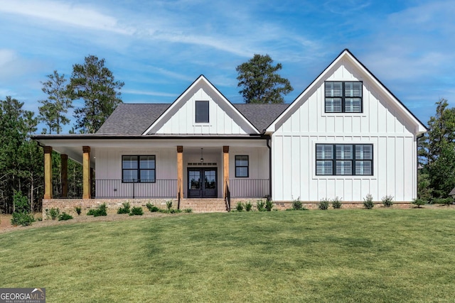 modern inspired farmhouse with a front lawn, a porch, and french doors