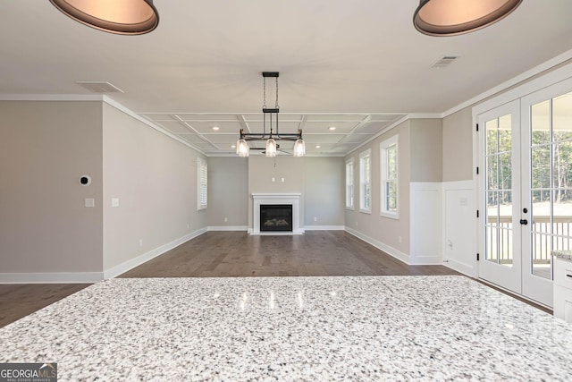 unfurnished living room featuring french doors, dark wood-type flooring, ornamental molding, and coffered ceiling