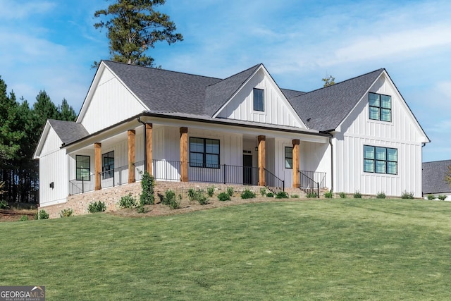 modern inspired farmhouse with a porch and a front lawn