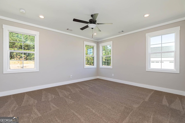 carpeted empty room with ceiling fan and crown molding