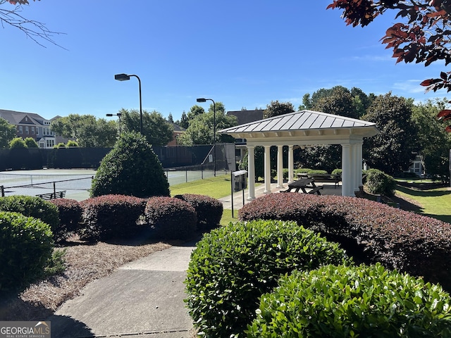 view of home's community featuring tennis court and a gazebo