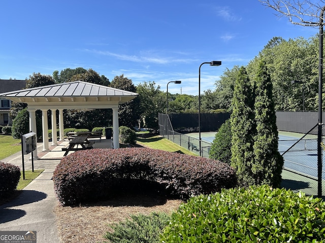 surrounding community with tennis court and a gazebo