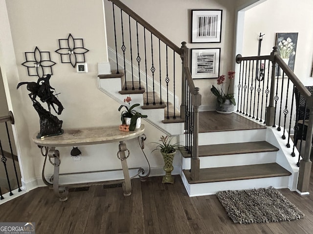 stairs featuring hardwood / wood-style flooring