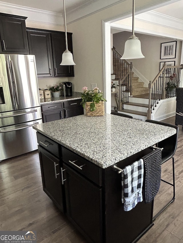 kitchen featuring decorative light fixtures, crown molding, stainless steel refrigerator with ice dispenser, and dark hardwood / wood-style flooring