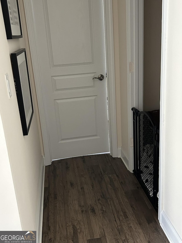 hallway featuring dark hardwood / wood-style flooring