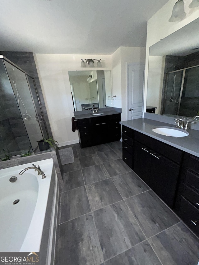 bathroom featuring vanity and separate shower and tub