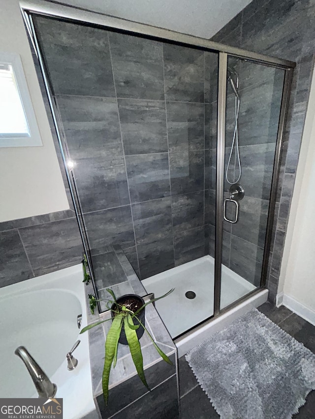 bathroom featuring separate shower and tub