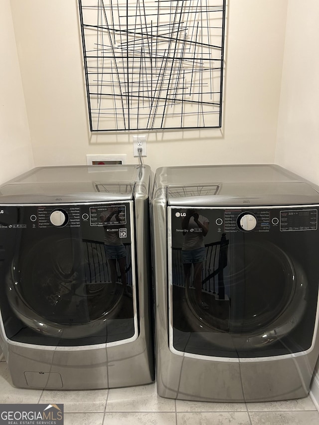 laundry area featuring tile patterned floors and washer and clothes dryer