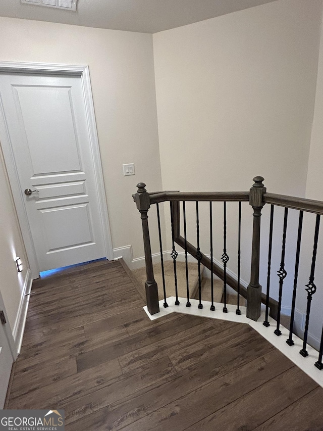 staircase with wood-type flooring