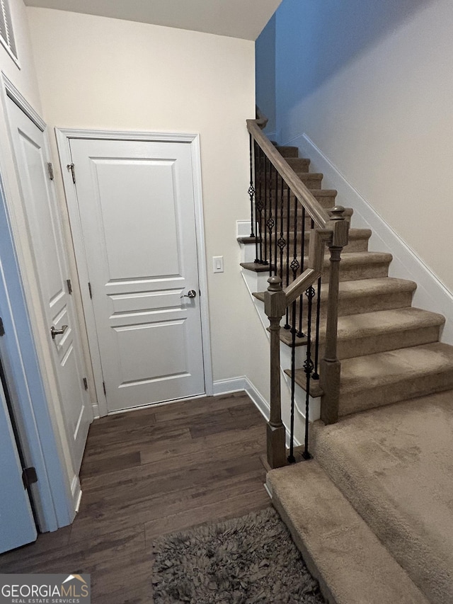 stairs with hardwood / wood-style floors