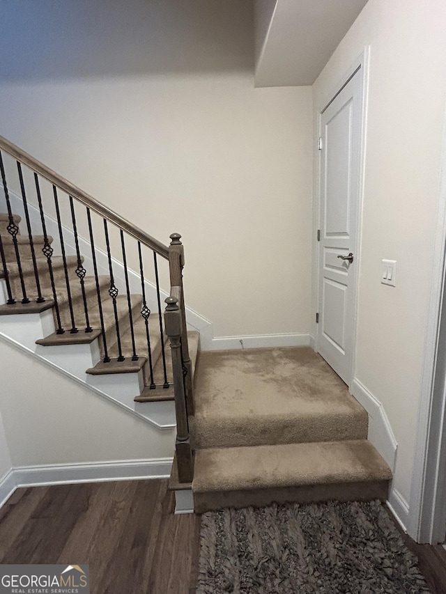 staircase featuring wood-type flooring