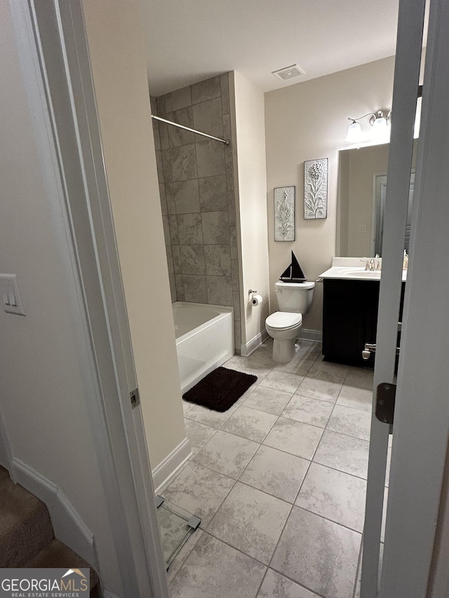 full bathroom with vanity, toilet, tiled shower / bath, and tile patterned flooring