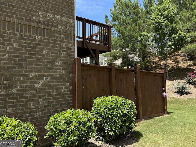 view of property exterior with a wooden deck and a yard