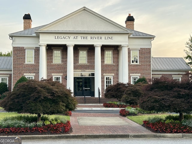 view of outdoor building at dusk