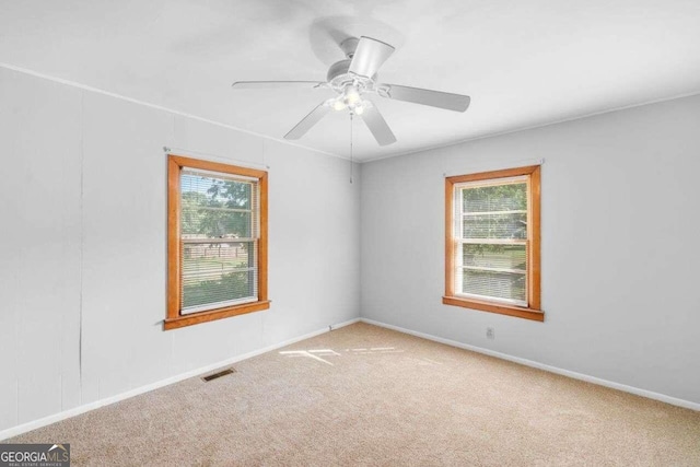 carpeted empty room with ceiling fan